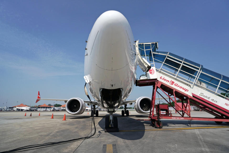 A grounded Lion Air Boeing Co. 737 Max 8 aircraft sits on the tarmac at terminal 1 of Soekarno-Hatta International Airport in Cenkareng, Indonesia, on Tuesday, March 15, 2019. Sundays loss of an Ethiopian Airlines Boeing 737, in which 157 people died, bore similarities to the Oct. 29 crash of another Boeing 737 Max plane, operated by Indonesias Lion Air, stoking concern that a feature meant to make the upgraded Max safer than earlier planes has actually made it harder to fly. Photographer: Dimas Ardian/Bloomberg via Getty Images