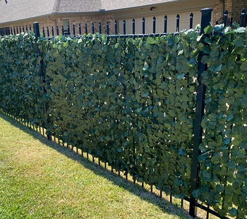 a reviewer photo of the vines on a slatted fence 