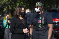 Democratic vice presidential candidate Sen. Kamala Harris, D-Calif., left, speaks with a supporter at the Busy Bee cafe during a campaign event, Friday, Oct. 23, 2020, in Atlanta. (AP Photo/John Amis)