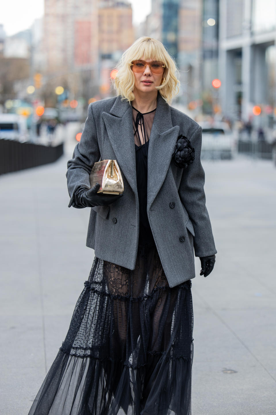 A woman wearing a black floral rosette brooch at NYFW