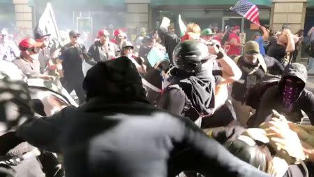 Protesters of the right-wing group Patriot Prayer clash with protesters from anti-fascist groups during a demonstration in Portland, Oregon, U.S. June 30, 2018, in this still image taken from video from obtained from social media. Bryan Colombo/via REUTERS