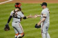 San Francisco Giants pitcher Jake McGee, right, and catcher Buster Posey celebrate after a baseball game against the Philadelphia Phillies, Tuesday, April 20, 2021, in Philadelphia. (AP Photo/Matt Slocum)