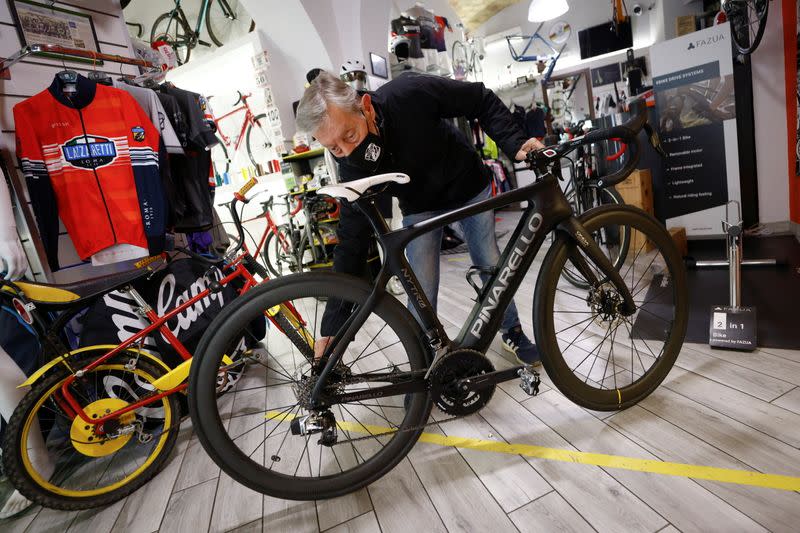 Mario Carbutti shows an electric bike at his shop in Rome