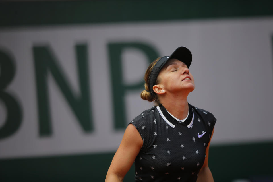 Romania's Simona Halep reacts after missing a shot against Amanda Anisimova of the U.S. during their quarterfinal match of the French Open tennis tournament at the Roland Garros stadium in Paris, Thursday, June 6, 2019. Halep lost in two sets 2-6, 4-6. (AP Photo/Michel Euler)