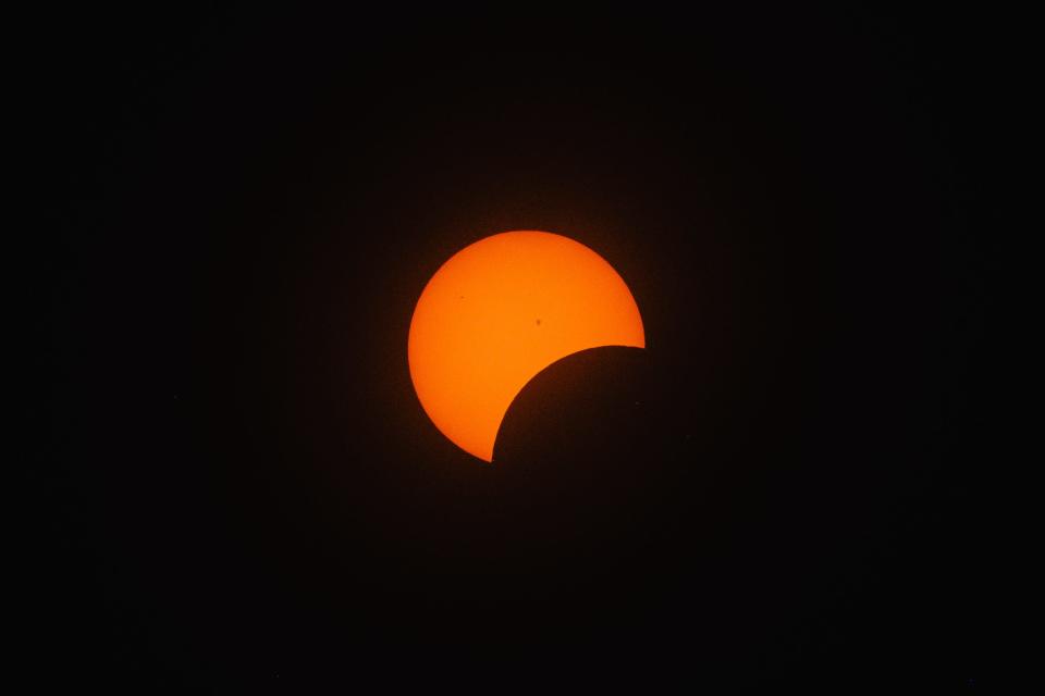 The moon is seen eclipsing the sun at 2:27 p.m., EDT, during a watch party for the 2024 solar eclipse held at Trumpet in the Land, the site of Ohio’s official state play, Monday, April 8, in New Philadelphia. While New Philadelphia was not in the path of totality, viewers experienced 99.32% obscuration of the sun at 3:15 p.m., EDT.