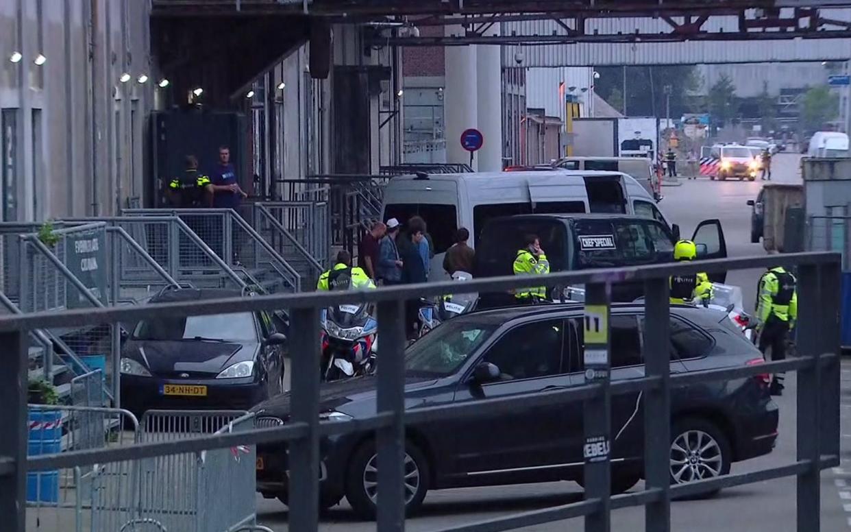 In this image taken from video people and security stand around a van in Rotterdam, Wednesday Aug. 23, 2017, after a concert by an American rock band was cancelled Wednesday night following a threat, the city's mayor said. Police detained the driver of a van with Spanish license plates carrying a number of gas tanks inside - RTL via AP