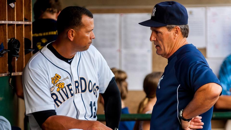 Jul 3, 2013; Charleston, SC, USA; New York Yankees third baseman Alex Rodriguez, as part of the Charleston RiverDogs, speaks with Yankees Director of Player development Pat Roessler after leaving the game following the third inning of a rehab game against the Rome Braves at Joseph P. Riley, Jr. Park.