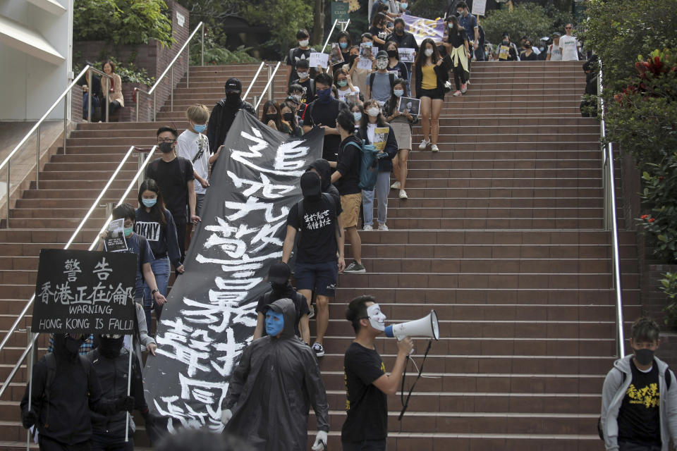 Pro-democracy university students gather at the campus of the University of Hong Kong, Wednesday, Nov. 6, 2019 against police brutality. Hong Kong police say an anti-government supporter stabbed and wounded a pro-Beijing Hong Kong lawmaker who was campaigning for local elections Wednesday, marking another escalation in five months of protests. The banner with Chinese reads: "Investigate police brutality, support students." (AP Photo/Kin Cheung)