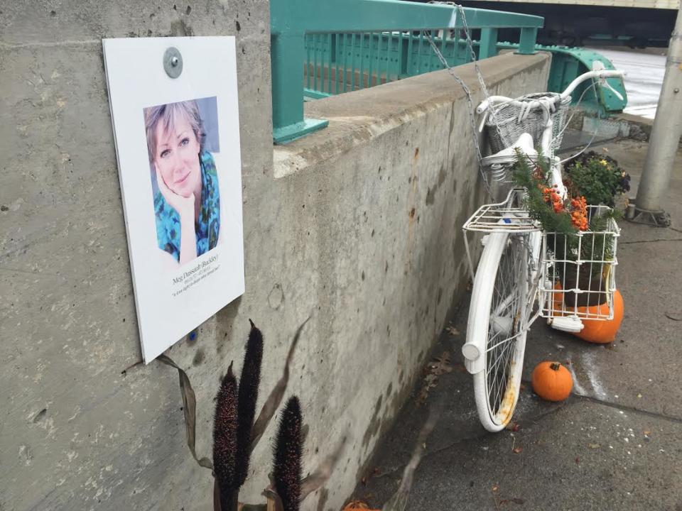 A photo of Meg Dussault and a ghost bike in her honour are at the corner of Bank St. and Riverside Dr., where she was hit by a cement truck and killed in July 2013.