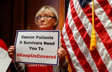 A woman holds a sign during a press conference held by U.S. Sen. Bob Casey, D-Pa., to speak out against the latest Republican effort to repeal Obamacare on Capitol Hill in Washington, U.S., September 25, 2017. REUTERS/Kevin Lamarque