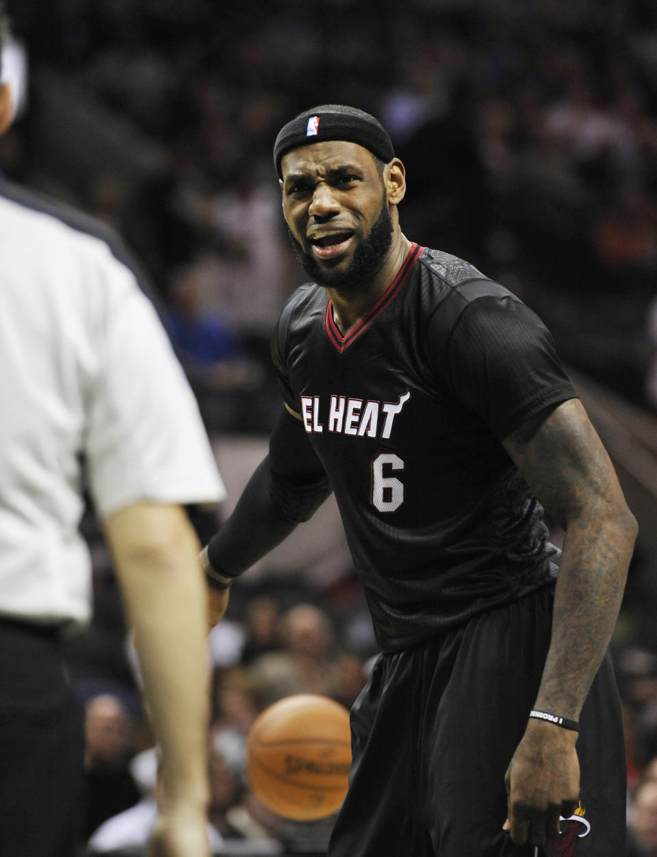 Miami Heat forward LeBron James, right, disagrees with an official during the second half of an NBA basketball game against the San Antonio Spurs, Thursday, March 6, 2014, in San Antonio. San Antonio won 111-87. (AP Photo/Darren Abate)