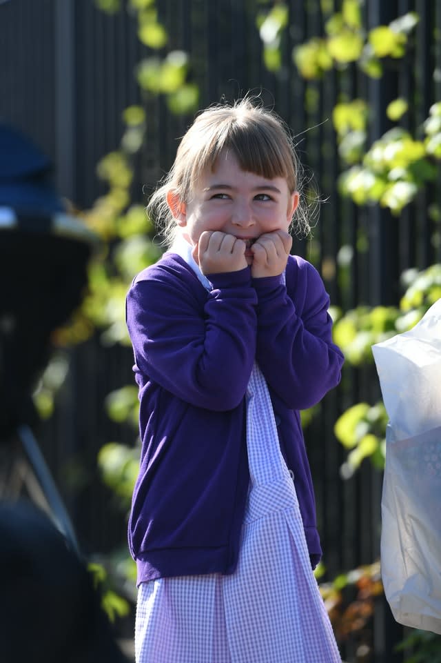 A pupil waits to head into school