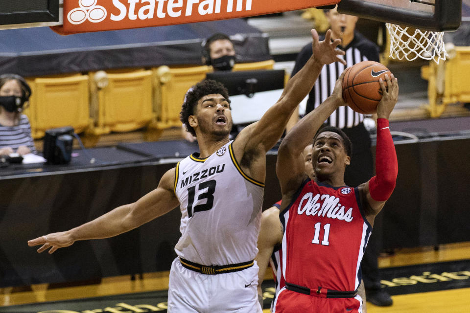 Mississippi's Matthew Murrell, right, shoots past Missouri's Mark Smith during the first half of an NCAA college basketball game Tuesday, Feb. 23, 2021, in Columbia, Mo. (AP Photo/L.G. Patterson)