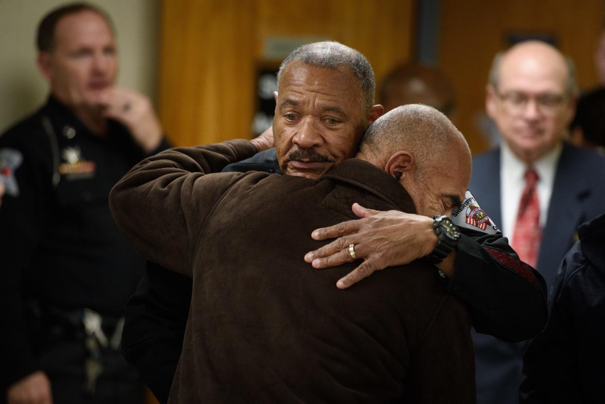 Chief Deputy O.J. Broadus III, left, consoles one of the family members of Cumberland County Sheriffs Deputy Oscar Yovani Bolanos-Anavisca Jr. at the end of a press conference on Friday, Dec. 16, 2022. Bolanos-Anavisca was struck and killed by an impaired driver on Gillespie Street early Friday.