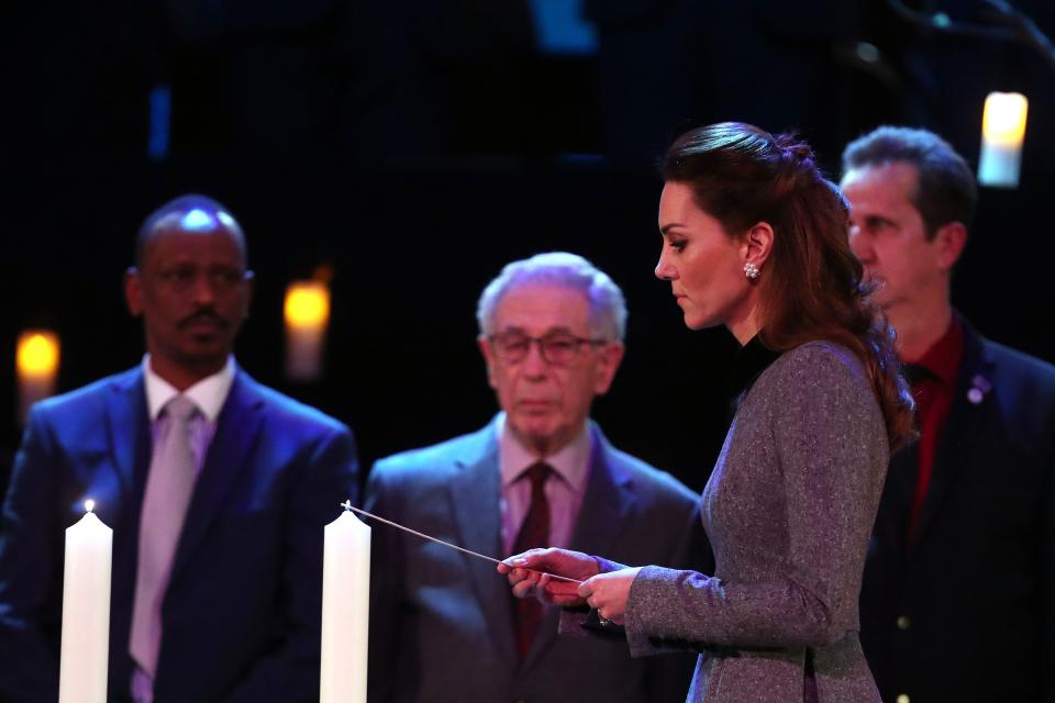 Britain's Catherine, Duchess of Cambridge lights a candle during the UK Holocaust Memorial Day Commemorative Ceremony at Methodist Central Hall in London on January 27, 2020. - Holocaust Memorial Day takes place each year on the 27th January, the anniversary of the liberation of Auschwitz-Birkenau, and honours survivors of the Holocaust, Nazi Persecution, and subsequent genocides in Cambodia, Rwanda, Bosnia and Darfur. 2020 marks the 75th anniversary of the liberation of Auschwitz-Birkenau.