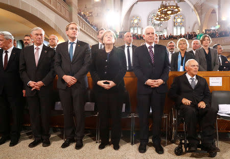 German Chancellor Angela Merkel, President of Germany's lower house of parliament Bundestag Wolfgang Schaeuble and President of the Central Council of Jews in Germany Josef Schuster take part in a ceremony to mark the 80th anniversary of Kristallnacht, also known as Night of Broken Glass, at Rykestrasse Synagogue, in Berlin, Germany, November 9, 2018. REUTERS/Fabrizio Bensch