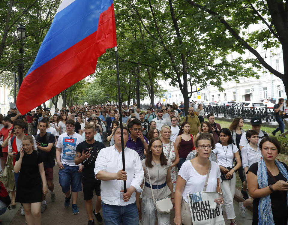 Supporters of Russian investigative journalist Ivan Golunov and other protesters gather to attend a march in Moscow, Russia, Wednesday, June 12, 2019. (AP Photo/Pavel Golovkin)