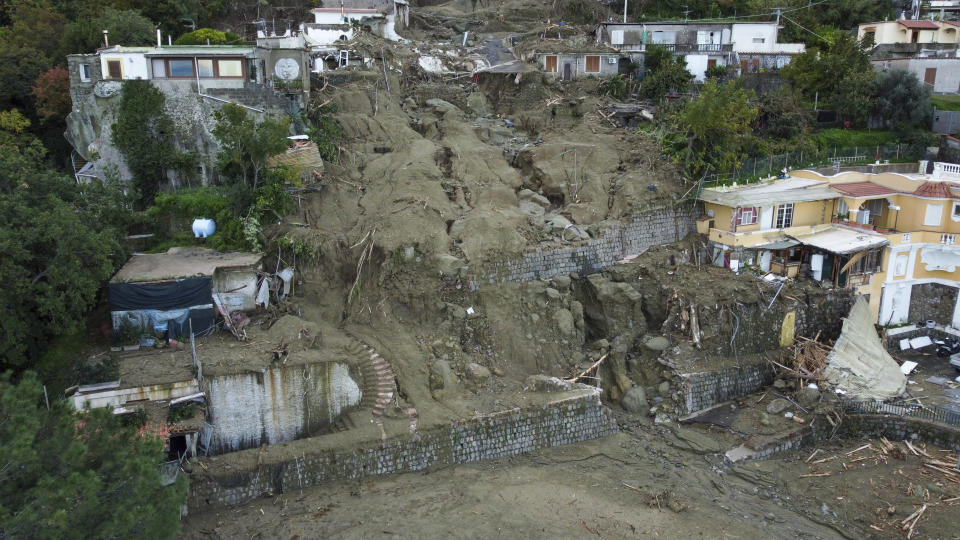 An aerial view of damaged houses after heavy rainfall triggered landslides that collapsed buildings and left as many as 12 people missing, in Casamicciola, on the southern Italian island of Ischia, Sunday, Nov. 27, 2022. Authorities said that the landslide that early Saturday destroyed buildings and swept parked cars into the sea left one person dead and 12 missing. (AP Photo/Salvatore Laporta)