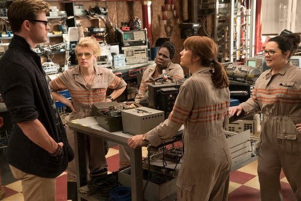 the female ghostbusters team looks askance at their receptionist, kevin