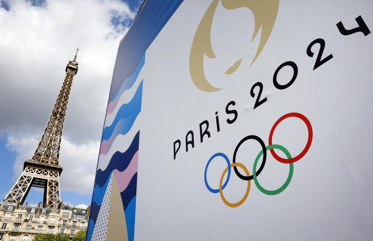 The Paris 2024 logo, representing the Olympic Games is displayed near the Eiffel Tower