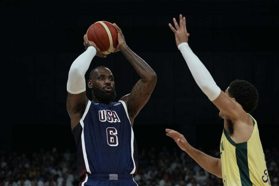 America's LeBron James (left) takes a shot while Australia's Josh Green (right) attempts a block during the USA Basketball Showcase in Abu Dhabi, United Arab Emirates, Monday, July 15, 2024. (AP Photo/Altaf Qadri)