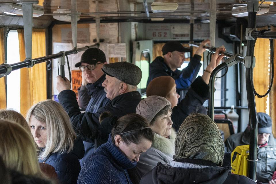 In this photo taken on Monday, April 15, 2019, people ride a trolley bus in Kryvyi Rih, in eastern Ukraine. Residents of the industrial city complain about a low standard of living and soaring utilities bills. Many in the city support Volodymyr Zelenskiy, an actor and comedian from the city, in the runoff election on Sunday, April 21, against President Petro Poroshenko. (AP Photo/Evgeniy Maloletka)