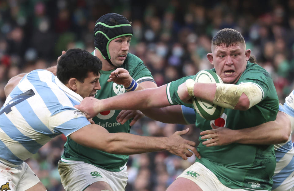 Ireland's Tadhg Furlong, right, is tacked by Argentina's captain Julian Montoya, behind, and teammate Guido Petti during the rugby union international match between Ireland and Argentina at the Aviva Stadium in Dublin, Ireland, Sunday, Nov. 21, 2021. (AP Photo/Peter Morrison)