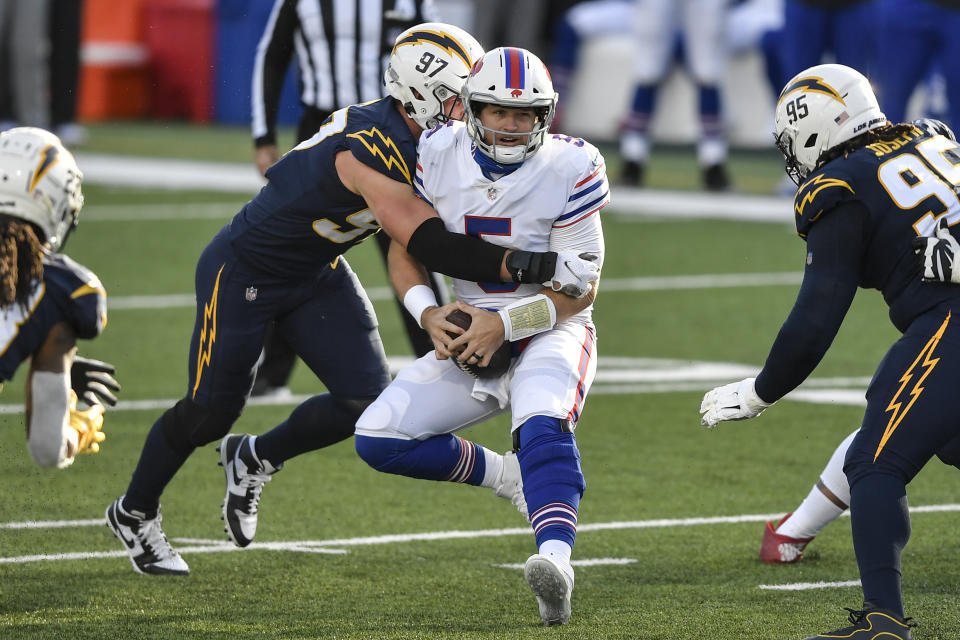 Buffalo Bills quarterback Matt Barkley (5) is sacked by Los Angeles Chargers defensive end Joey Bosa (97) during the first half of an NFL football game, Sunday, Nov. 29, 2020, in Orchard Park, N.Y. (AP Photo/Adrian Kraus)