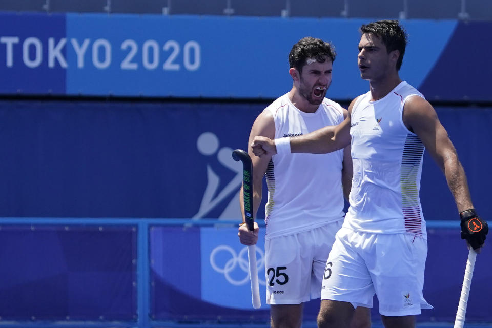 Belgium defender Loick Fanny A Luypaert (25) celebrates after Belgium defender Alexander Robby P Hendrickx, right, scored against the Netherlands during a men's field hockey match at the 2020 Summer Olympics, Saturday, July 24, 2021, in Tokyo, Japan. (AP Photo/John Locher)