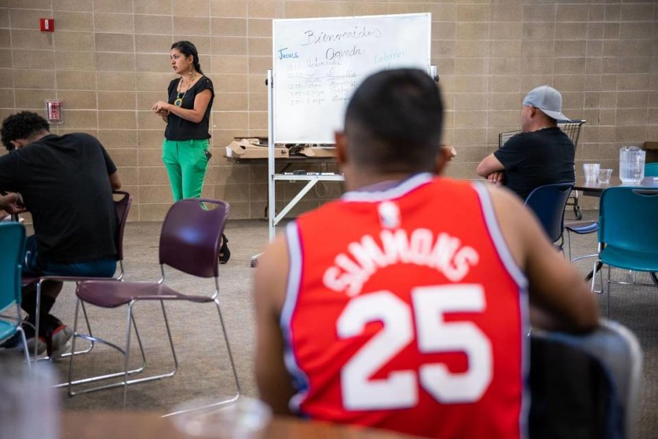 Gabby Trejo, executive director of ACT, speaks Thursday to the migrants who were flown to Sacramento by Florida during a day of activities at a local church.