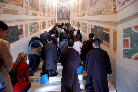 Worshippers pray on the Holy Stairs in Rome, Italy April 16 2019. REUTERS/Remo Casilli