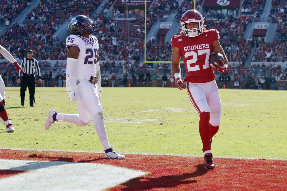 Oklahoma Sooners running back Gavin Sawchuk (27) runs for a touchdown beside TCU Horned Frogs safety Jamel Johnson (25) during a college football game between the University of Oklahoma Sooners (OU) and the TCU Horned Frogs at Gaylord Family-Oklahoma Memorial Stadium in Norman, Okla., Friday, Nov. 24, 2023.