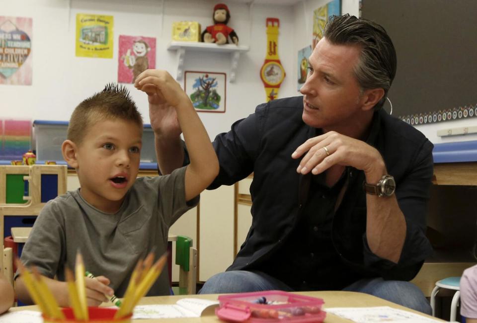 Gov. Gavin Newsom talks with kindergartner Leonardo Castrejon.