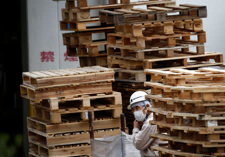 FILE PHOTO: A worker takes a rest at a warehouse at the Keihin Industrial Zone in Kawasaki, Japan September 12, 2018. REUTERS/Kim Kyung-Hoon