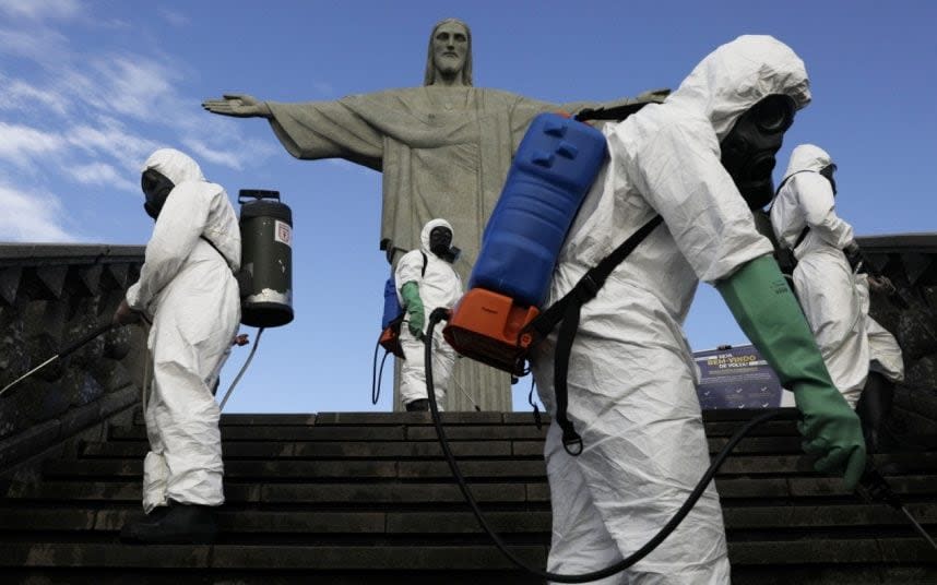 Members of the military disinfect the statue - REUTERS/RICARDO MORAES  