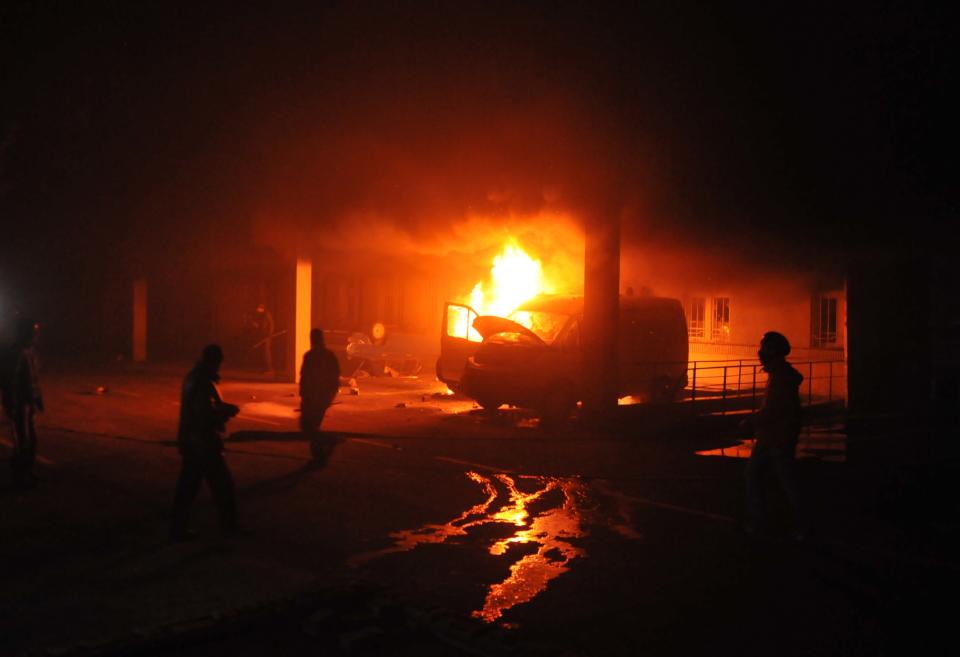 Ukrainian protesters burn a cars outside a Security Service headquarters in Lviv, western Ukraine, early Wednesday, Feb. 19, 2014. The violence on Tuesday was the worst in nearly three months of anti-government protests that have paralyzed Ukraine's capital, Kiev, in a struggle over the identity of a nation divided in loyalties between Russia and the West, and the worst in the country's post-Soviet history. (AP Photo/ Pavlo Palamarchuk)