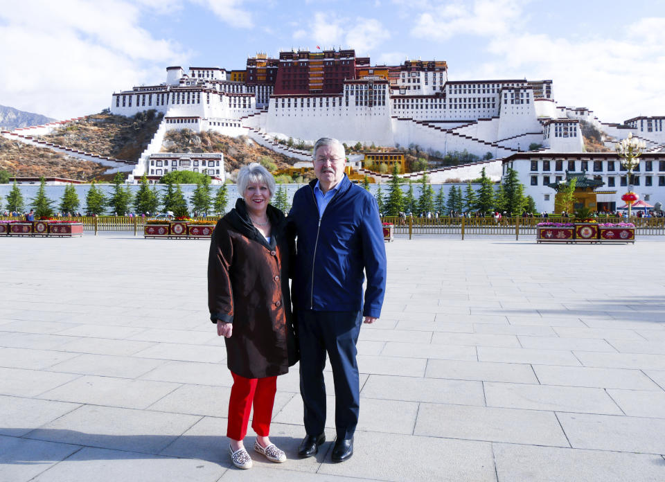 FILE - In this May 22, 2019 photo released by the U.S. Embassy in Beijing, U.S. Ambassador to China Terry Branstad and his wife Christine pose for a photo in front of the Potala Palace in Lhasa in western China's Tibet Autonomous Region. Branstad appears to be leaving his post, based on tweets by Secretary of State Mike Pompeo. Pompeo thanked Branstad for more than three years of service on Twitter on Monday, Sept. 14, 2020. (U.S. Mission to China via AP, File)