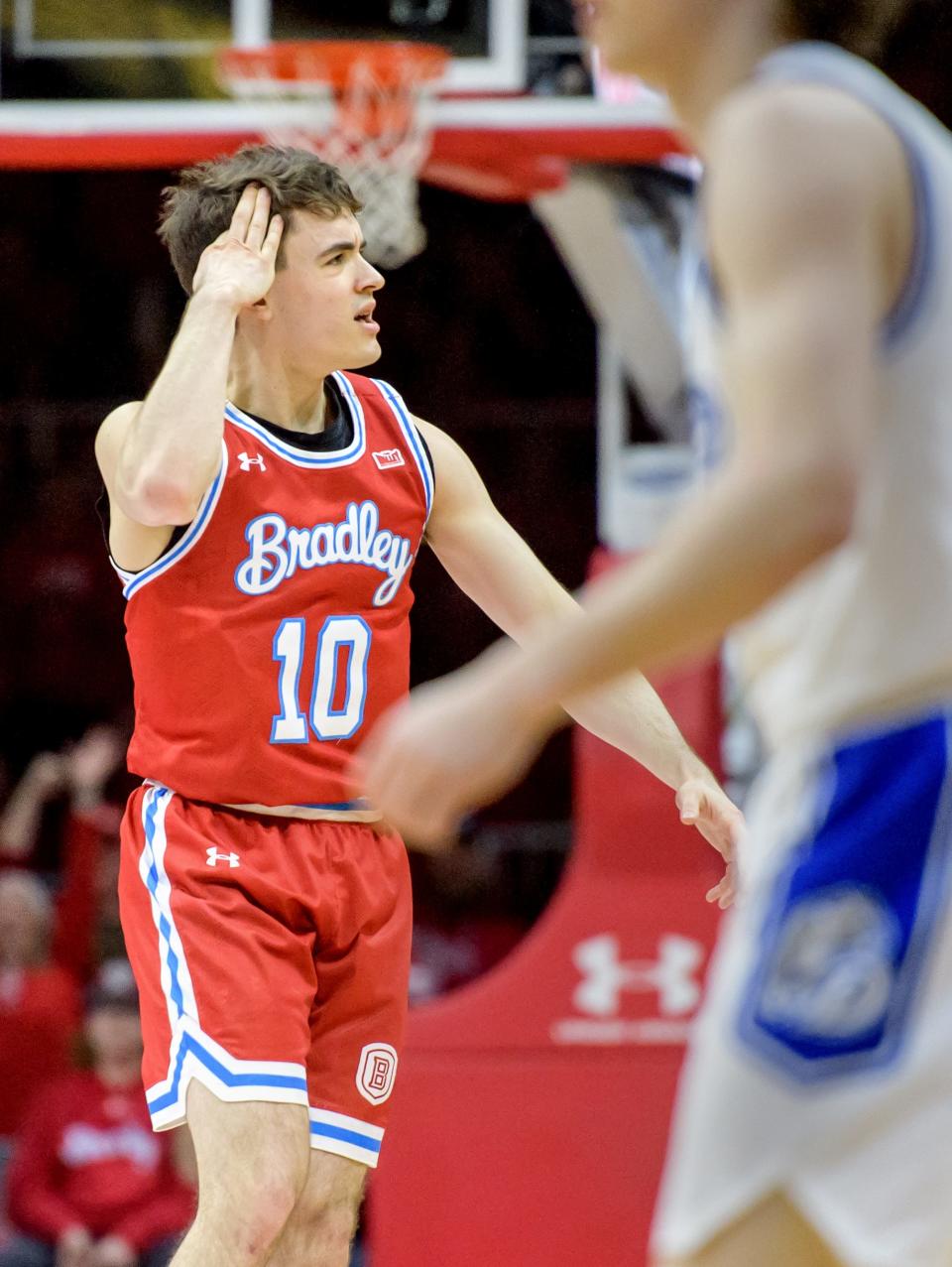 Bradley's Connor Hickman signals three-points after sinking a three-pointer against Drake in the first half Sunday, Feb. 26, 2023 at Carver Arena. The Braves defeated the Bulldogs 73-61.