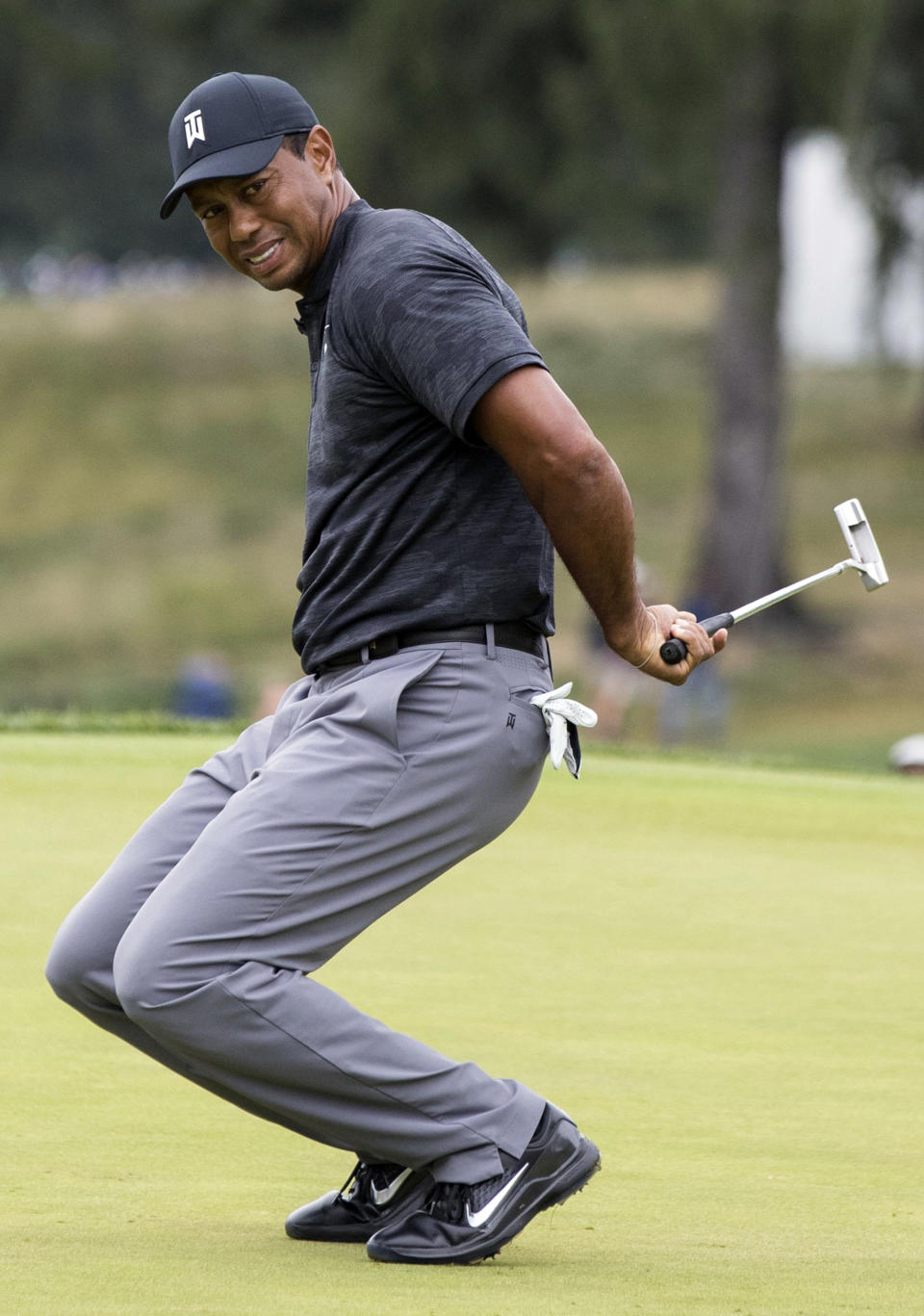 Tiger Woods reacts after missing a putt for a birdie on the fourth green during the BMW Championship golf tournament at the Aronimink Golf Club in Newtown Square, Pa., Saturday, Sept. 8, 2018. (Charles Fox/The Philadelphia Inquirer via AP)