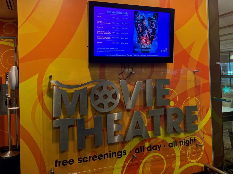 The screen at Changi's free movie theater showing the movies and times each day.