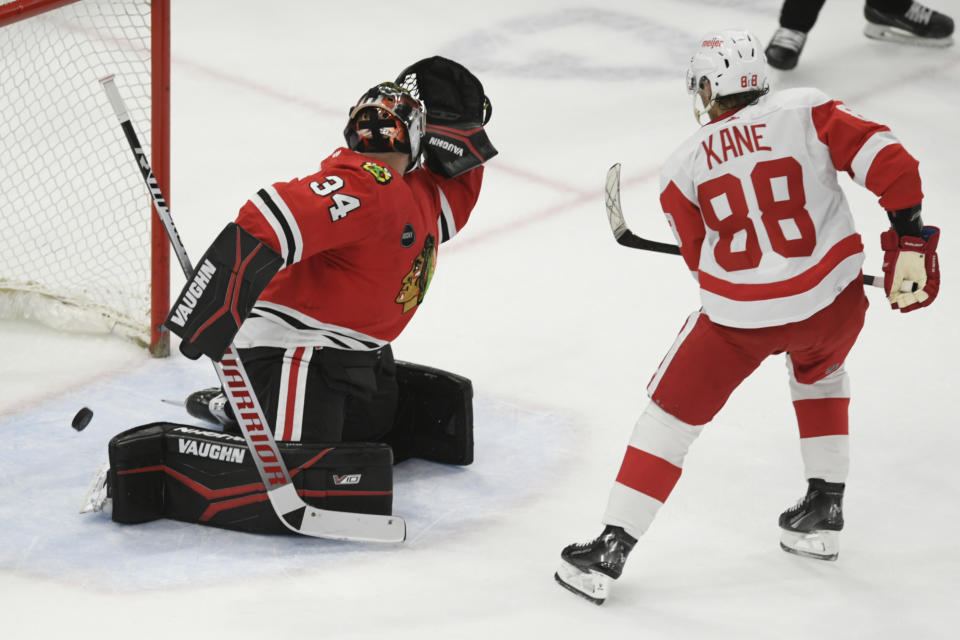 Detroit Red Wings' Patrick Kane (88) scores the winning goal against Chicago Blackhawks goalie Petr Mrazek (34) to win in overtime of an NHL hockey game Sunday, Feb. 25, 2024, in Chicago. (AP Photo/Paul Beaty)