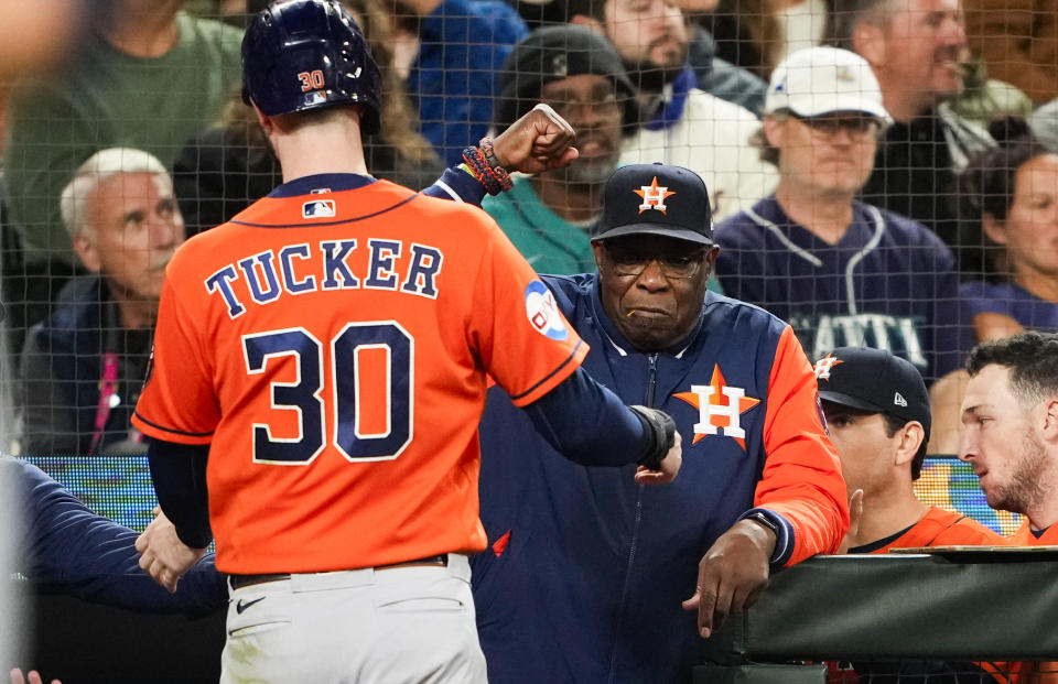 Houston Astros manager Dusty Baker Jr., right, greets Kyle Tucker (30), who scored against the Seattle Mariners during the seventh inning of a baseball game Wednesday, Sept. 27, 2023, in Seattle. (AP Photo/Lindsey Wasson)