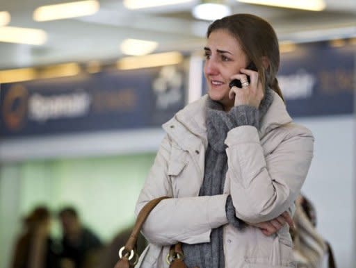 A Spanair's employee cries during a meeting at the Son Sant Joan airport in Palma de Mallorca. Spanair filed for voluntary bankruptcy Monday, officials said, three days after abruptly stopping all flights and stranding tens of thousands of passengers