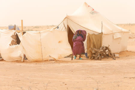 A Libyan woman displaced from the town of Tawergha stands at a camp in the Garart al-Gatef, Libya March 25, 2018. REUTERS/Ismail Zitouny