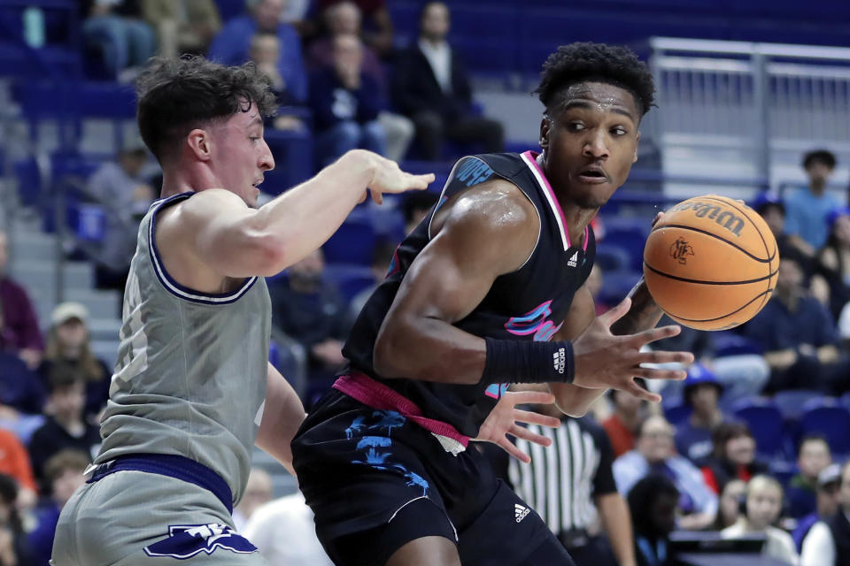 Florida Atlantic guard Brandon Weatherspoon, right, drives around Rice guard Alem Huseinovic, left, during the first half of an NCAA college basketball game Wednesday, Jan. 24, 2024, in Houston. (AP Photo/Michael Wyke)