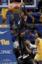 Miami guard Jordan Miller (11) dunks in front of Pittsburgh forward Blake Hinson (2) during the first half of an NCAA college basketball game in Pittsburgh, Saturday, Jan. 28, 2023. (AP Photo/Matt Freed)