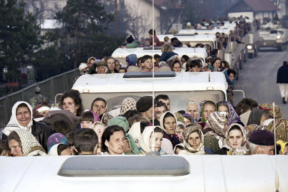 FILE- In this Monday, March 29, 1993 file picture, more than 2,000 refugees from the besieged Muslim enclave of Srebrenica arrive on a United Nations convoy, in Tuzla. Survivors of the genocide in the eastern Bosnian town of Srebrenica, mainly women, will on Saturday July 11, 2020, commemorate the 25th anniversary of the slaughter of their fathers and brothers, husbands and sons. At least 8,000 mostly Muslim men and boys were chased through woods in and around Srebrenica by Serb troops in what is considered the worst carnage of civilians in Europe since World War II. The slaughter was also the only atrocity of the brutal war that has been confirmed an act of genocide. (AP Photo/Michel Euler, File)