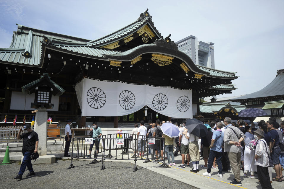 People pay respects to the war dead at Yasukuni Shrine Monday, Aug. 15, 2022, in Tokyo. Japan marked the 77th anniversary of its World War II defeat Monday. (AP Photo/Eugene Hoshiko)