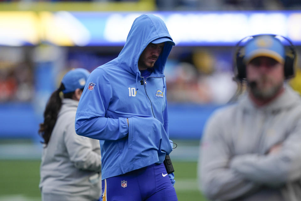 Los Angeles Chargers quarterback Justin Herbert walks on the sidelines after an injury with his hand in his hoodie pocket during the second half of an NFL football game against the Denver Broncos, Sunday, Dec. 10, 2023, in Inglewood, Calif. (AP Photo/Ryan Sun)