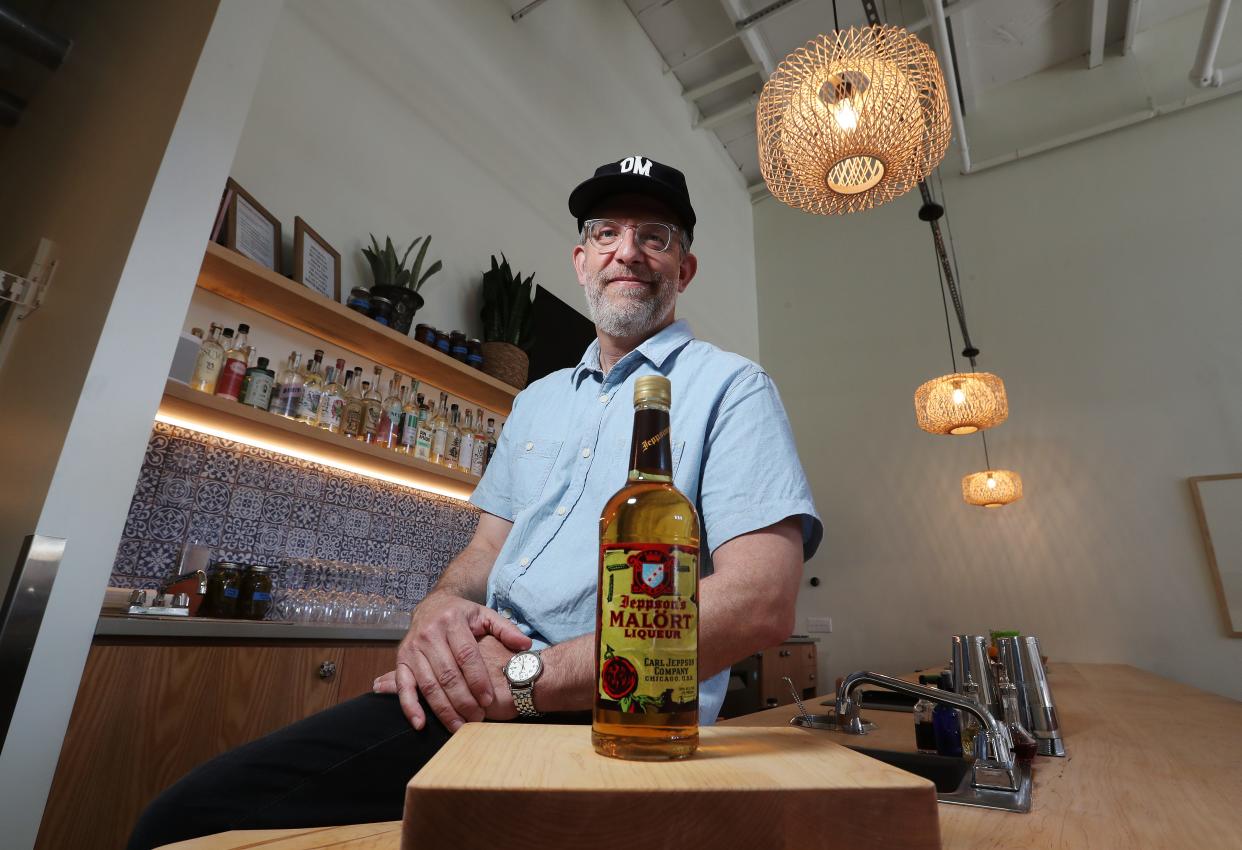 John Douglass, owner of Pretty Decent, with a bottle of Jeppson's Malört Liqueur in Louisville, Ky. on May. 31, 2023.